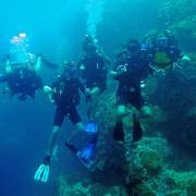 Family scuba diving at Sail Rock i the Gulf of Thailand